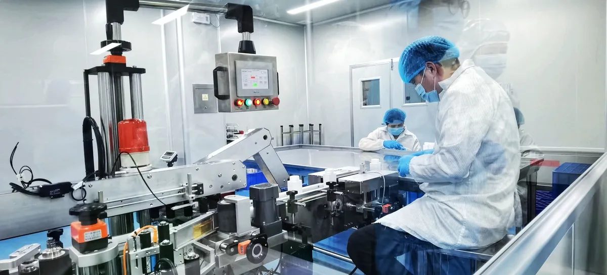 ATXA staff operating equipment on the bottle packaging line